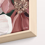Framed artwork of a floral design with a gold border on a white background
