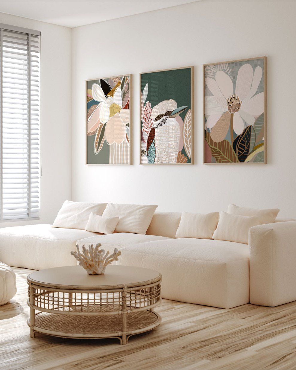 A set of three framed art prints featuring floral and bird motifs, displayed above a white sofa in a modern living room setting.