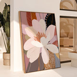 A framed canvas print featuring a floral composition with a large pink and white flower in the center, surrounded by various leaves and floral elements in a pastel color palette.