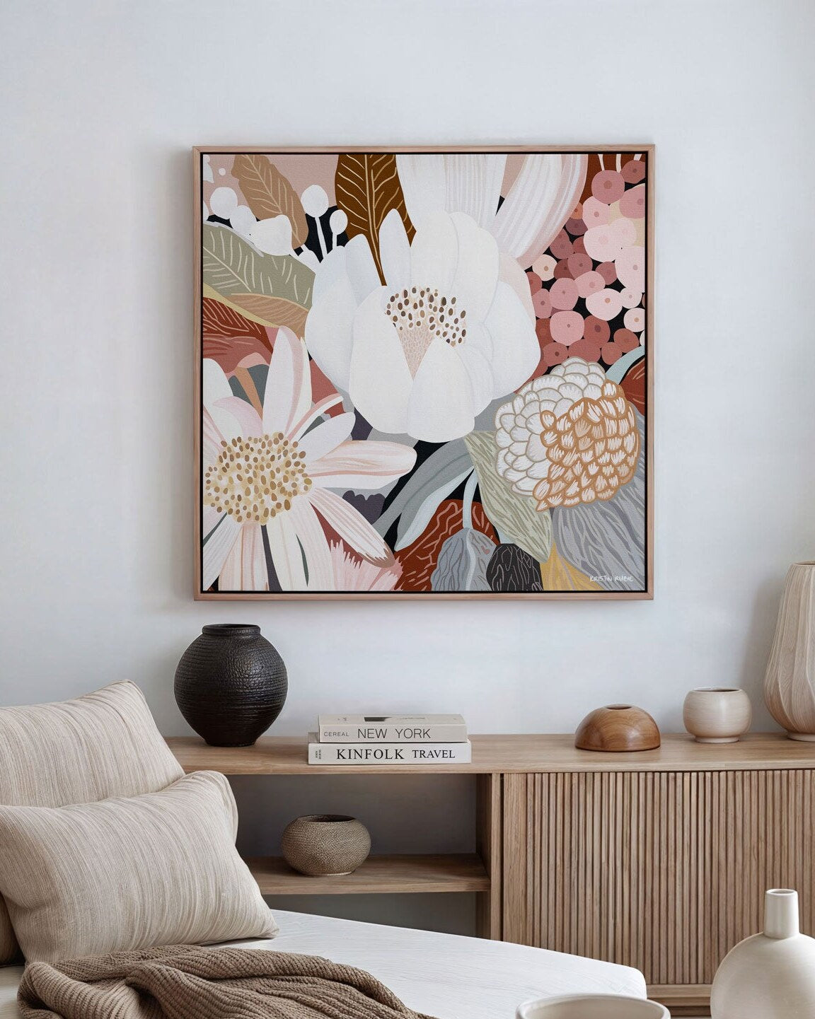 A framed canvas print titled 'Harmony No.2', featuring abstract floral forms in various colors on a living room wall.