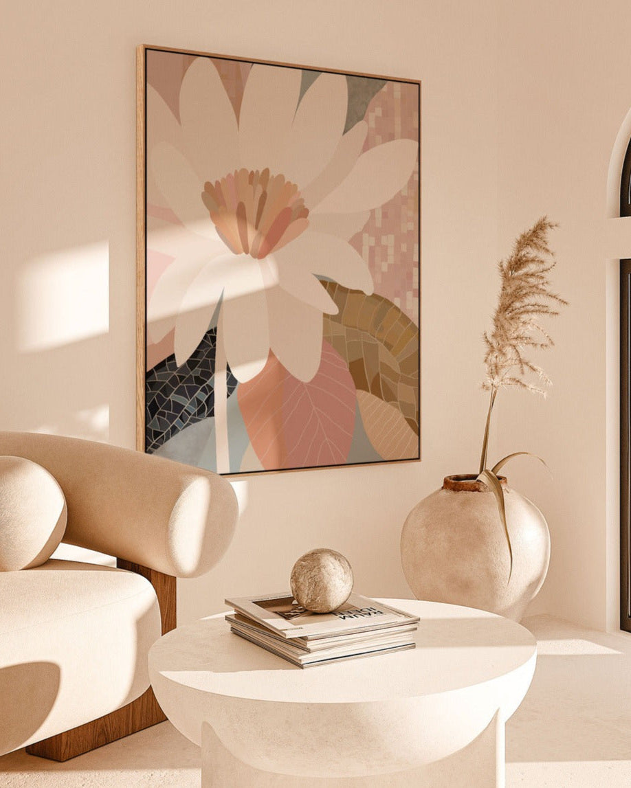 A framed canvas print titled 'Reverie', depicting an abstract floral arrangement in a soft color palette, displayed in a modern interior setting with minimalist furniture and decor.