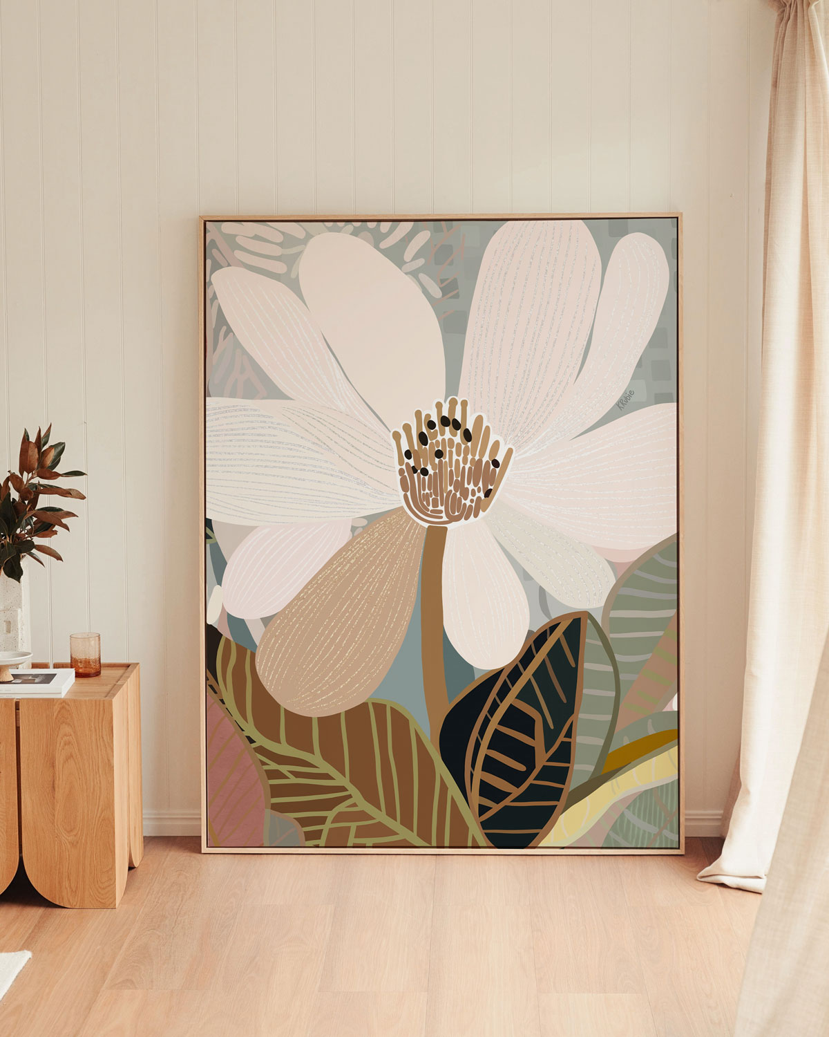 A framed canvas print of an abstract floral artwork featuring a magnolia flower with a calming palette of beige, white, and green colors.
