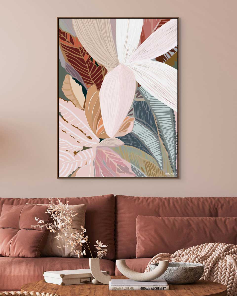 Framed abstract art piece on a wall above a sofa with decorative items on a table.