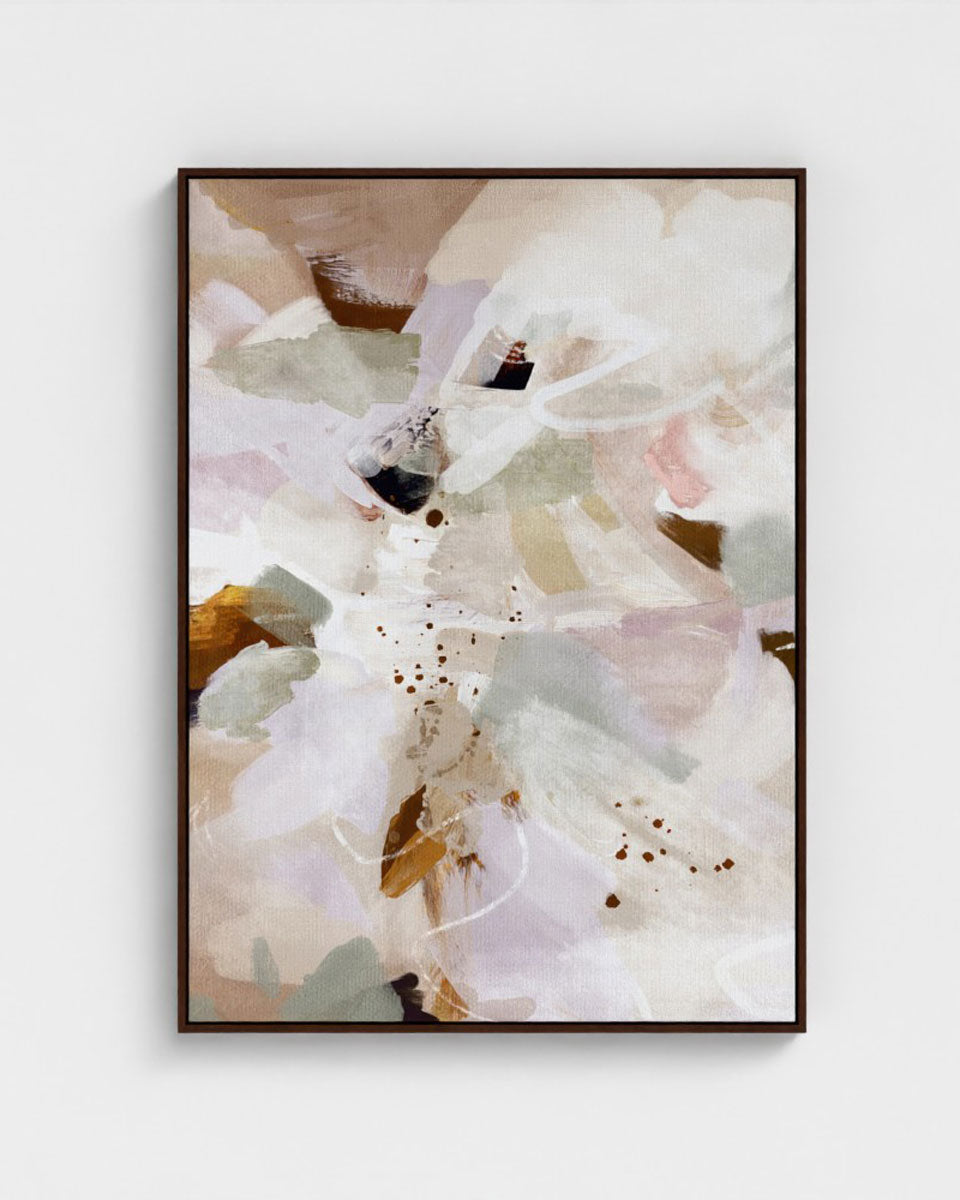 Abstract art print with soft colors in a black frame on a white wall
