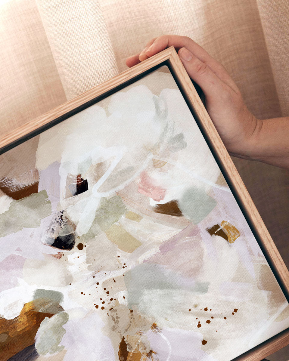 Framed abstract artwork with a hand holding it