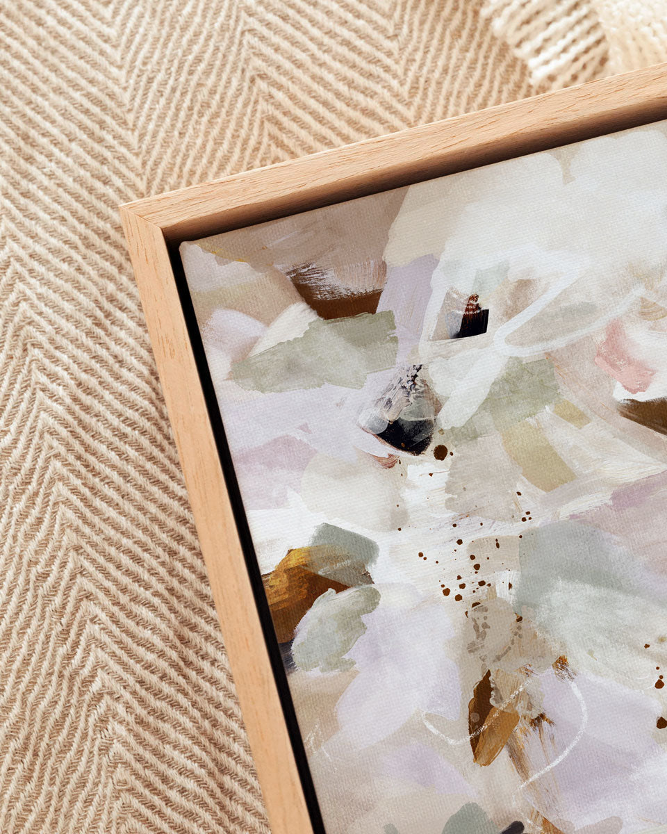 Framed abstract artwork on a textured beige wall