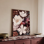 Floral painting on a wall above a dresser