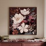 A framed floral wall art piece hangs above a console table. The artwork features large white and burgundy flowers with muted green and brown leaves on a dark brown background.
