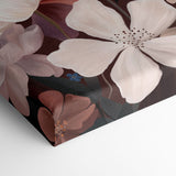 A close-up of a stretched canvas featuring large cream and dusty pink flowers with brown and muted purple accents on a dark background, shown folded over on a white surface.