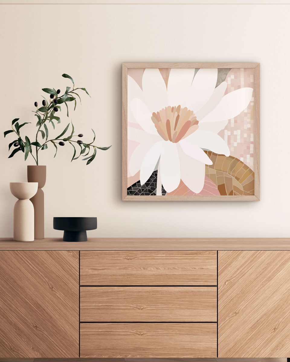 Framed floral artwork on a wall above a wooden cabinet with decorative items.