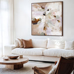 Modern living room with a white sofa, wooden coffee table, and abstract floral artwork.