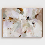 Abstract floral painting in a oak frame on a white wall