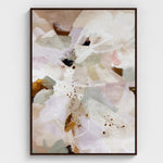 Abstract art print with soft colors in a black frame on a white wall