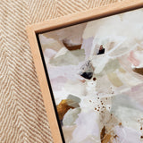 Framed abstract artwork on a textured beige wall